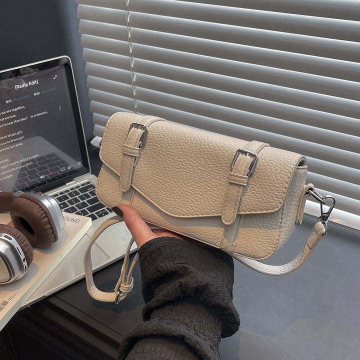 Women's elegant shoulder bag made of textured synthetic leather with adjustable shoulder strap