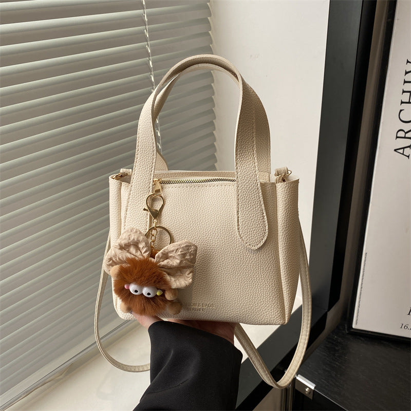 Women’s mini bag with playful animal pendant