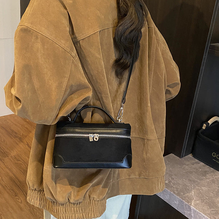 Women's shoulder bag made of soft suede leather with practical compartments