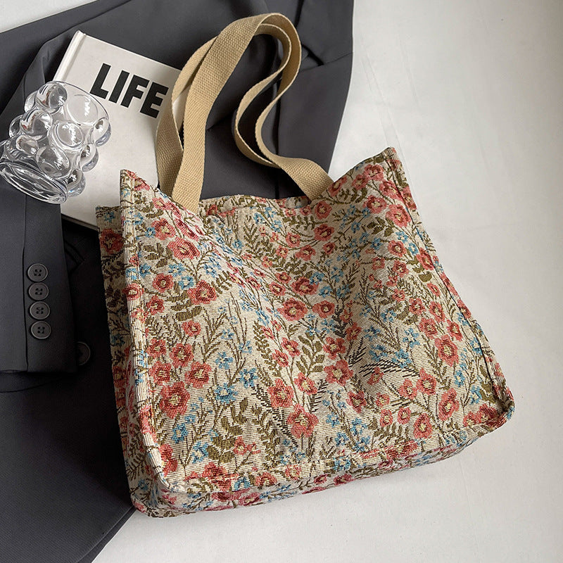 Women's tote bag with floral embroidery design and sturdy handles