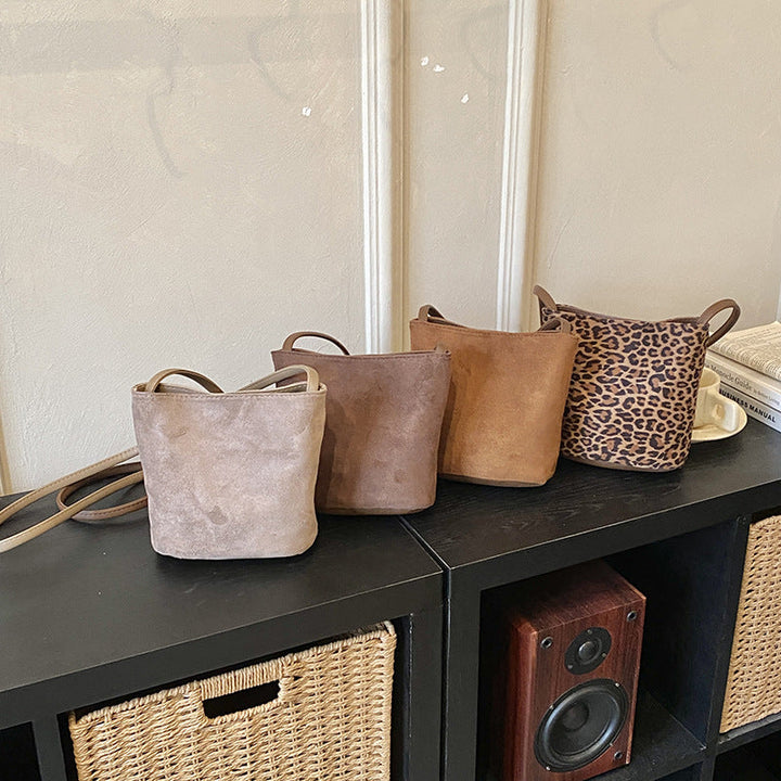 Women's mini bag made of soft suede with adjustable shoulder strap