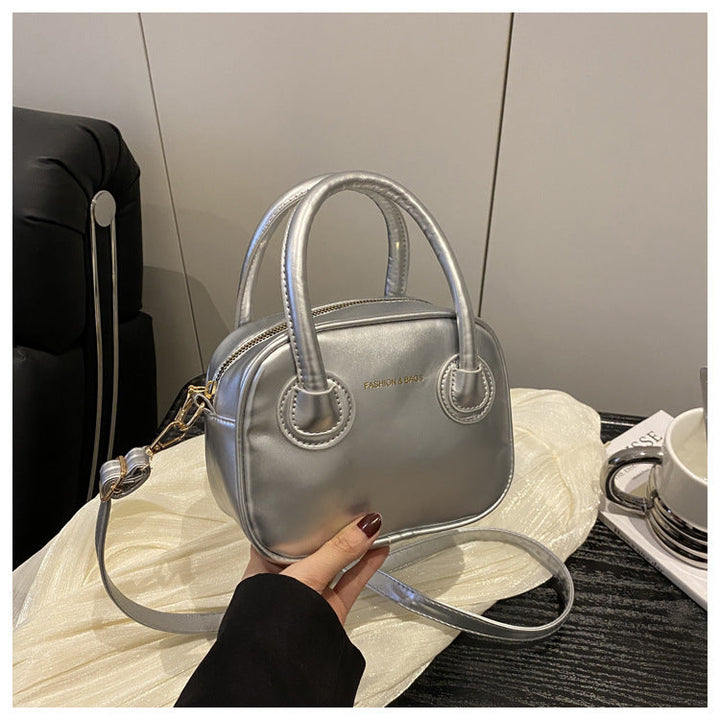 Ladies fashionable handbag with elegant pull handles and removable shoulder strap