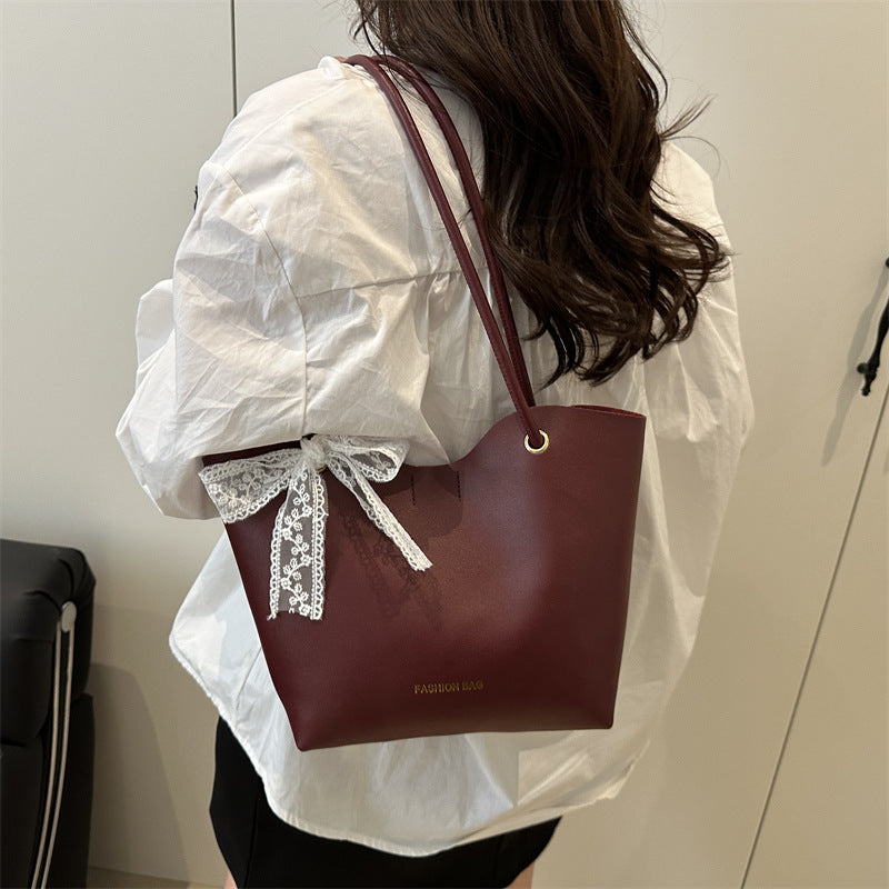 Women’s tote bag made of high-quality synthetic leather with playful bow detail