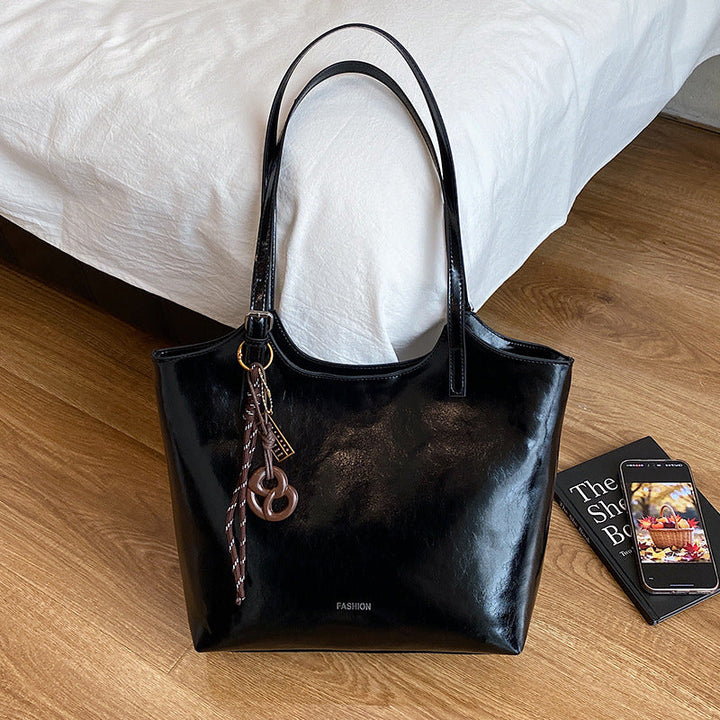 Ladies elegant tote handbag made of high-quality synthetic leather with playful pendant