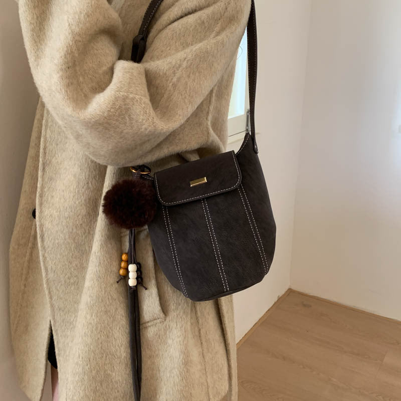 Ladies fashionable crossbody bag with fluffy pendant